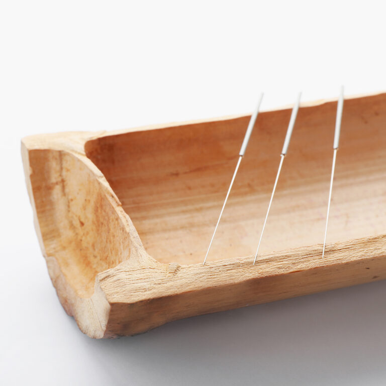 Bamboo stick with needles for acupuncture at Alma Acupuncture, located in El Paso, TX